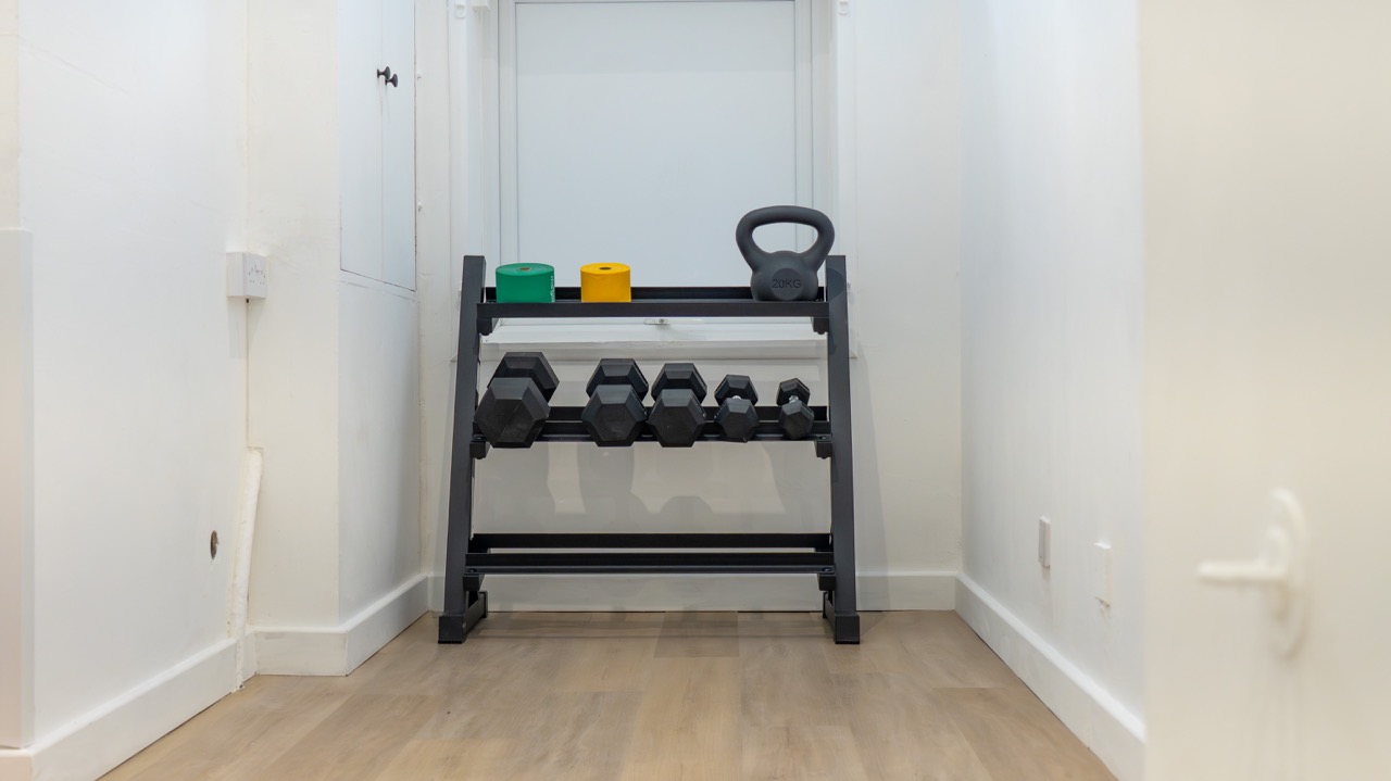 Rehab area with dumbbell rack, kettlebell and resistance bands