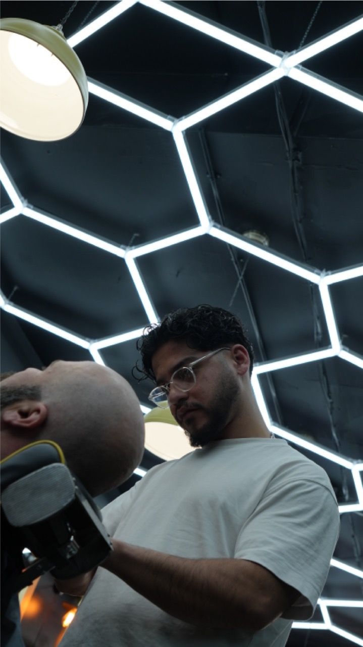 Barber clipper work shot from below through the hexagon lights