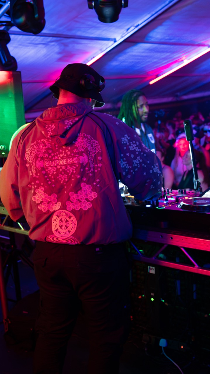 Goddard and Dread MC behind the decks under pink and purple lighting