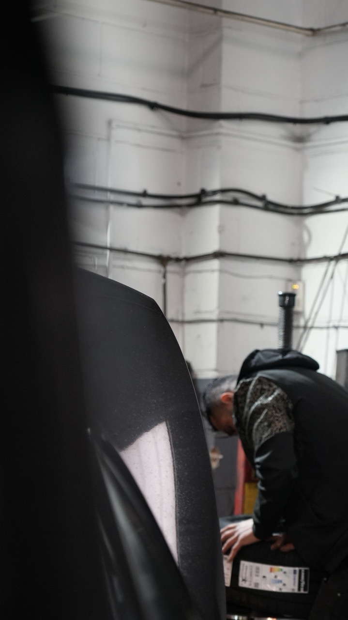 Technician checking a tyre in the Motor Sense workshop