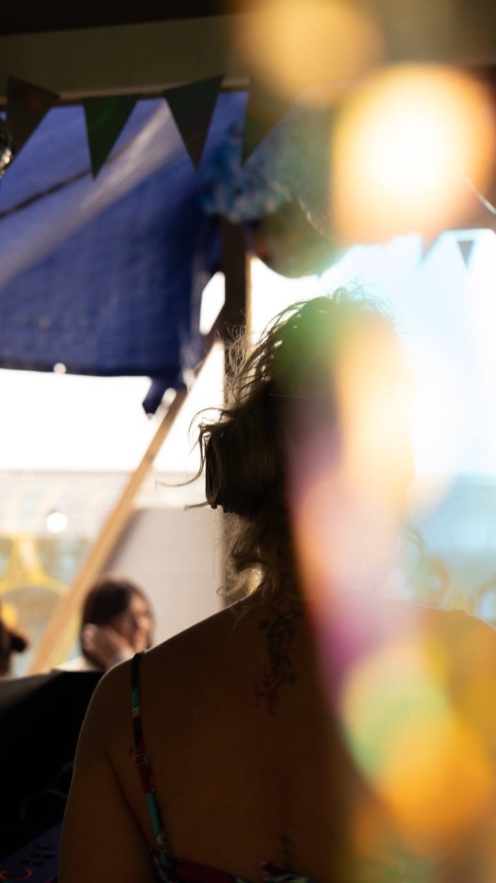 Golden-hour portrait through festival bunting
