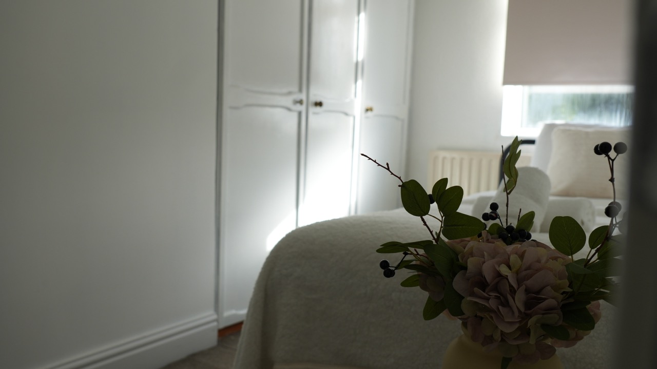 Bedroom detail with florals and fitted wardrobes in a Coventry serviced apartment