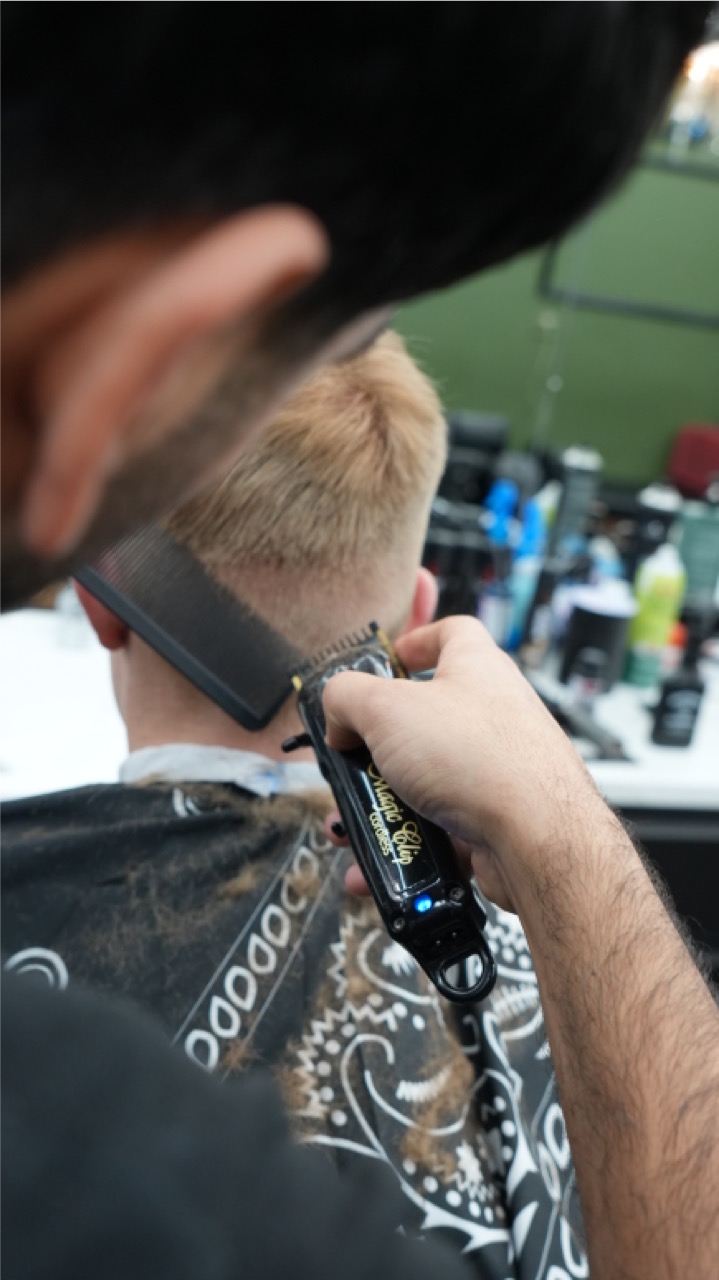 Clipper and comb detail on a fresh taper from behind