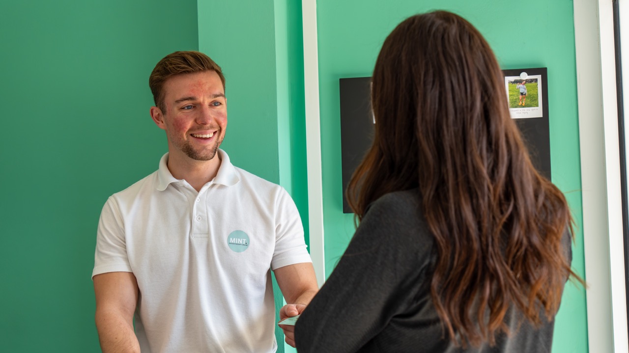 Physiotherapist greeting a patient at reception