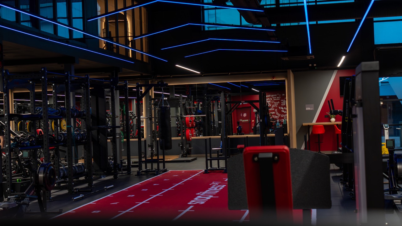 Gym floor with racks, sprint track and blue LED lighting
