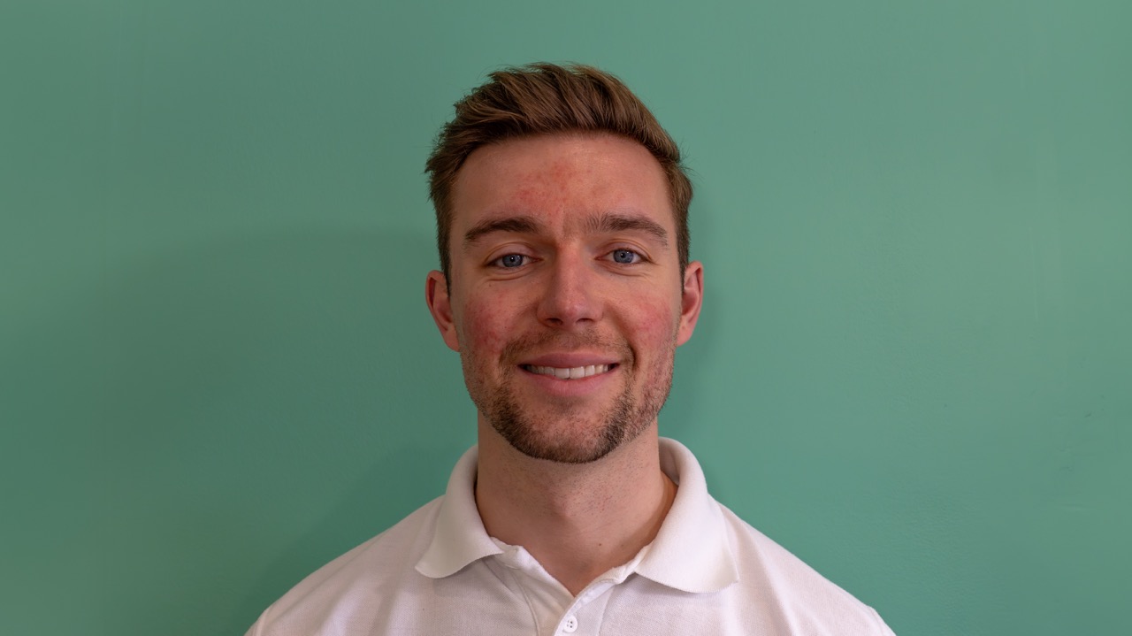 Clinic physiotherapist portrait against a green wall